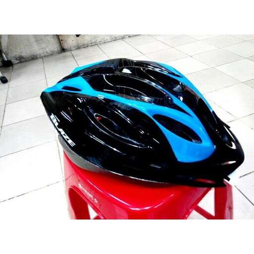a bike seat with a blue helmet on it.