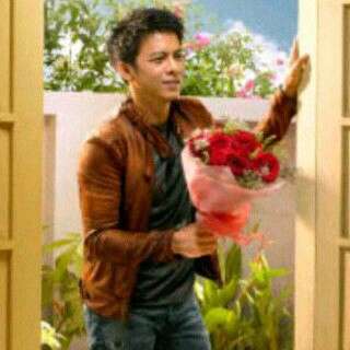 a boy gives flowers to a friend in the hotel