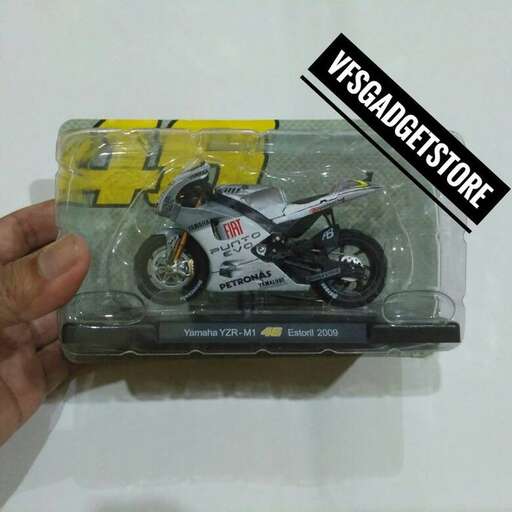 a person holding a box with a motorcycle inside.