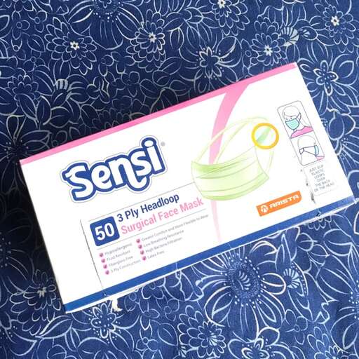 a box of toiletries on a blue fabric.