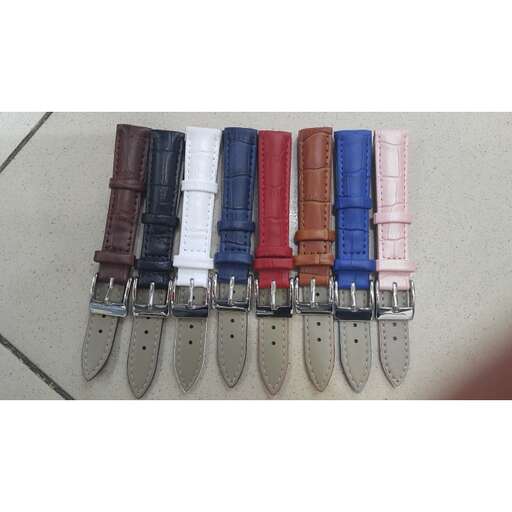 a row of leather pens lined up on a table.