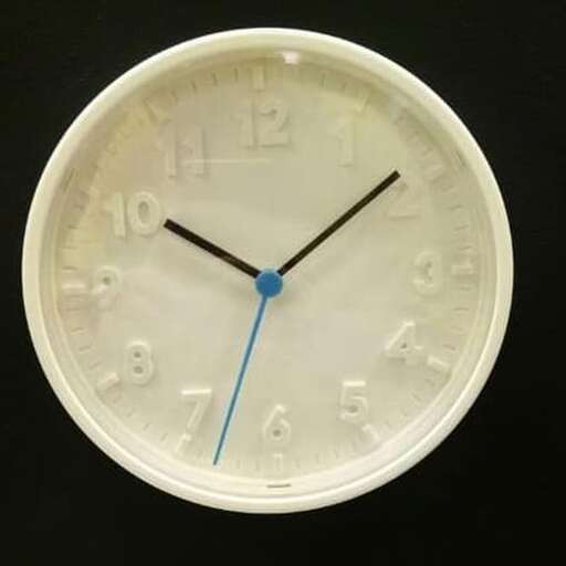 a white clock with a blue second hand on it.