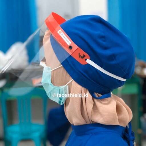a small child wearing a surgical mask and surgical gloves.