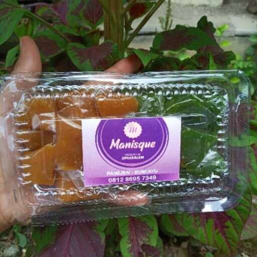 a hand holding a box of food.