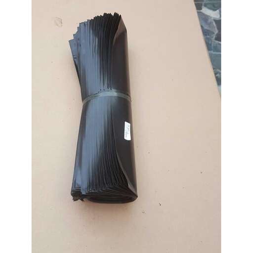 a piece of black paper is laying on a table.