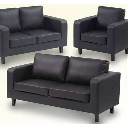 a black leather couch with a matching ottoman.