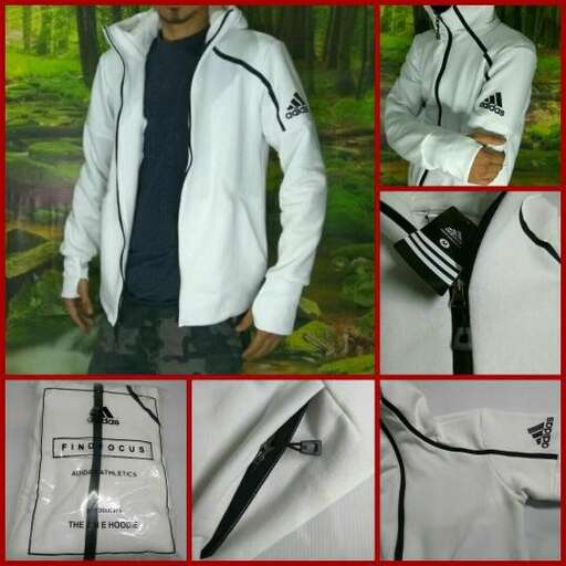 a white jacket with black stripes and a black tie.