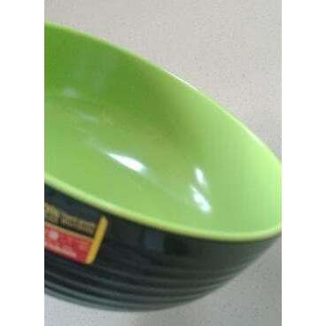 a green bowl with a black rim.