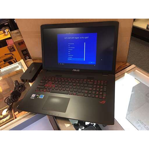a laptop computer sitting on a desk with a blue screen.