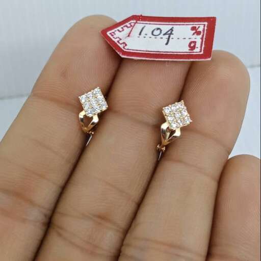 a pair of diamond earrings with a price tag.