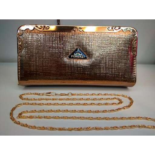 a gold purse with a diamond and chain.