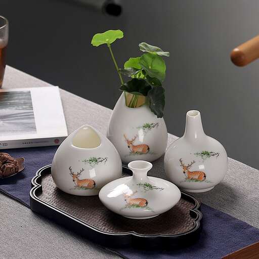 a tray with a vase and a plant on it