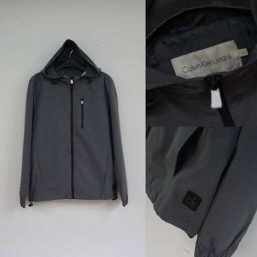 a jacket that is on a table with a tag.