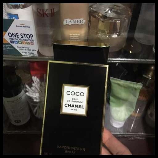 a bottle of perfume sitting on top of a shelf.