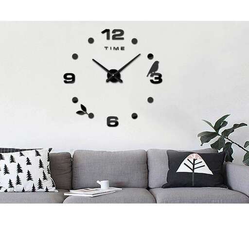 a gray couch with a clock on the wall.