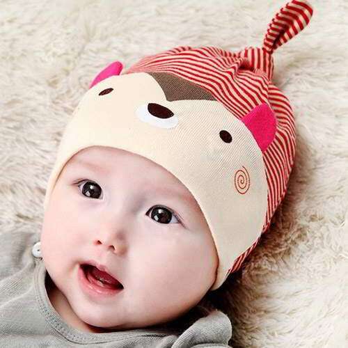 a baby wearing a hat on its head.