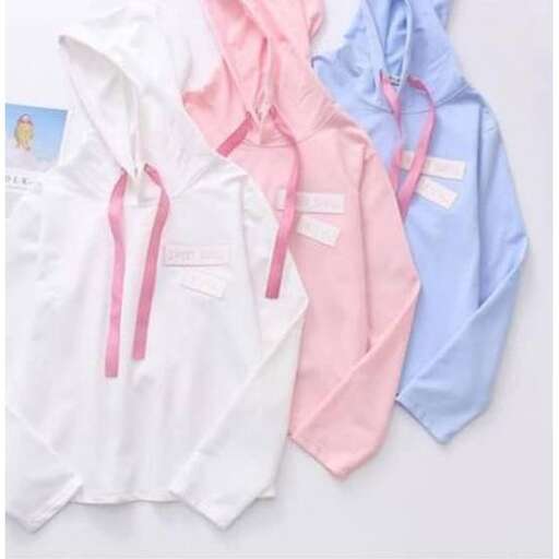 a group of different colored clothing on a table.