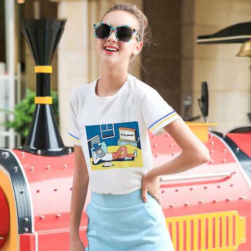 a model wears a t - shirt and sunglasses as she poses in front of a train