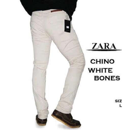 a man's white jeans with a black shirt underneath.