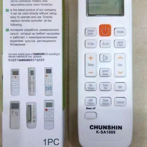 a white remote control sitting on top of a table.