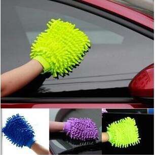 a person holding a sponge on a car window
