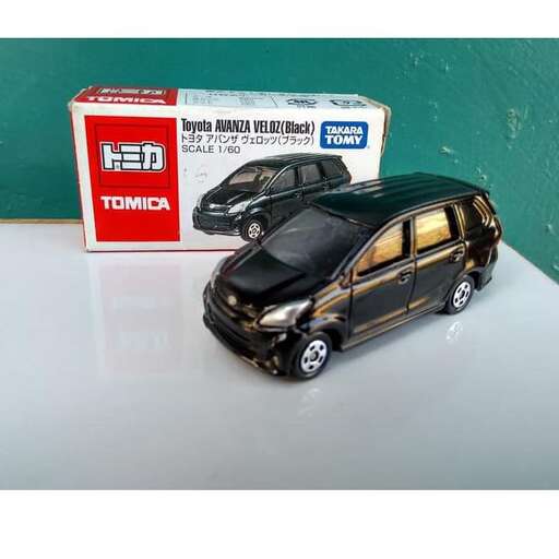 a small model car with a small car in the back.