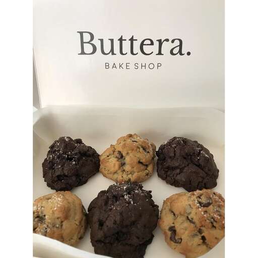 a box of chocolate muffins with chocolate chips in it.
