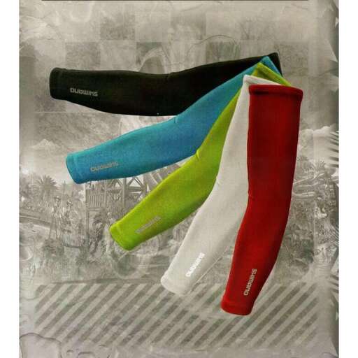 a pair of red and green clogs sitting on a metal shelf.