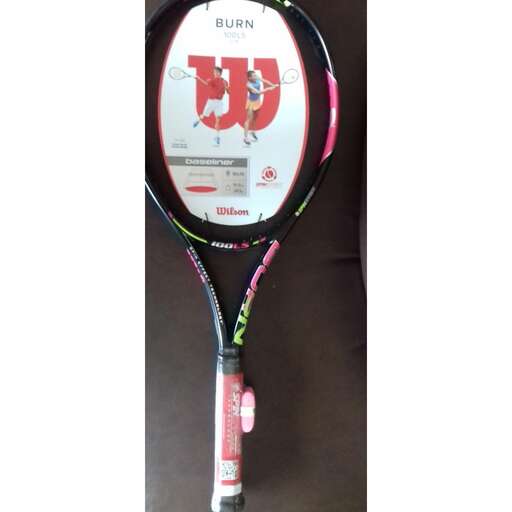 a tennis racket with a pink and green handle
