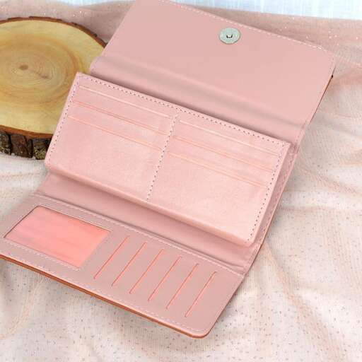 a pink leather wallet with a wooden log in the middle.