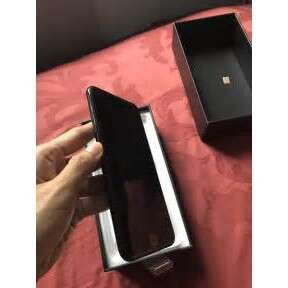 a hand holding a box with a box inside of it.