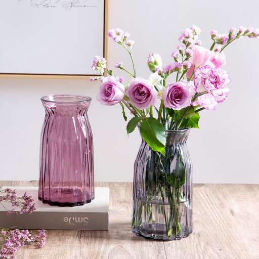 a vase of pink flowers on a table.