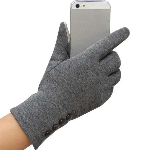a person wearing a glove holding a cell phone.