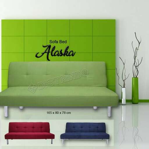 a green couch with a green accent wall.