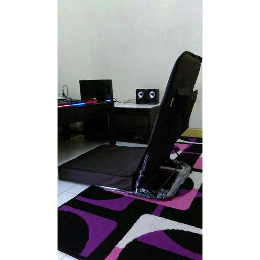 a chair and desk in a room with a rug.