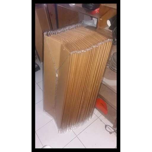 a stack of books on a white tiled floor.