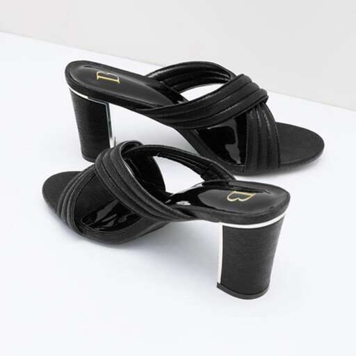 a pair of black leather sandals with a metallic buckle.