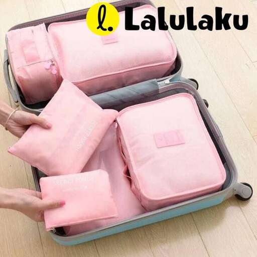a pair of pink and white pillows in a suitcase.
