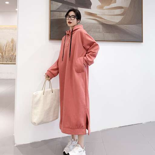 a long coat with a white bag