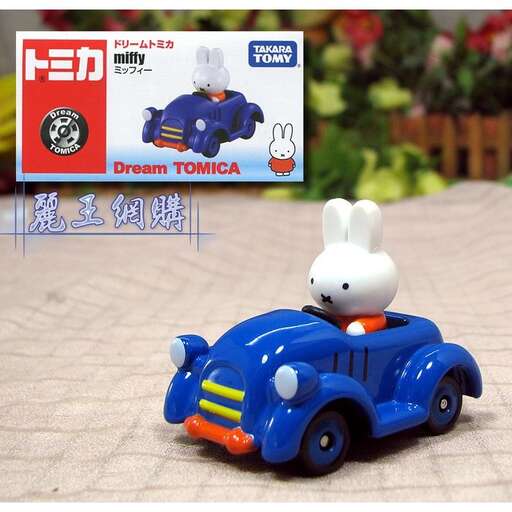 a toy car with a bunny on it sitting on a table.