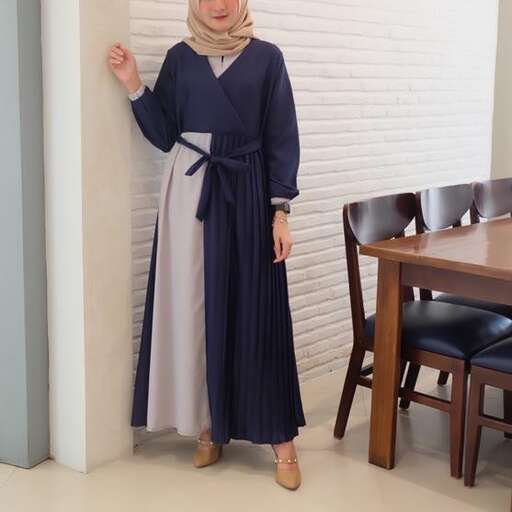 a woman in a dress standing in a room.