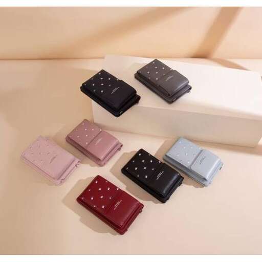 a white table topped with a pair of folded folded folded shirts.