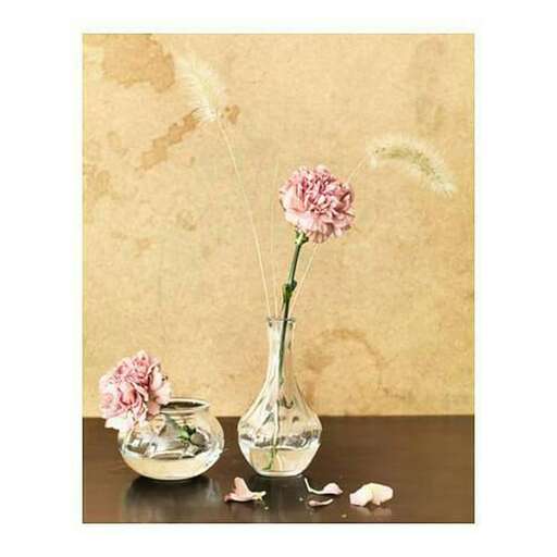 two vases with flowers in them on a table.