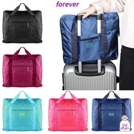 a woman carrying a suitcase and a bag.