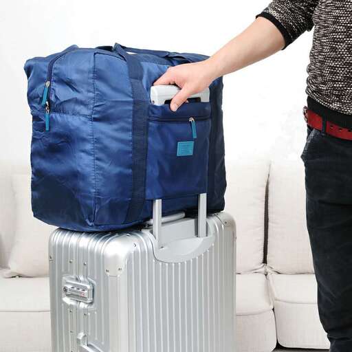 a woman is pulling a suitcase with a handle.