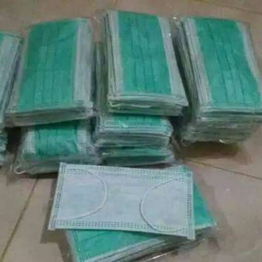 a pile of green paper on the floor.