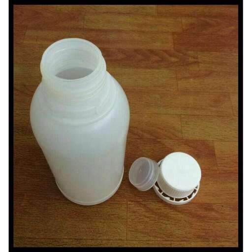 a bottle and a bottle of milk on a table.