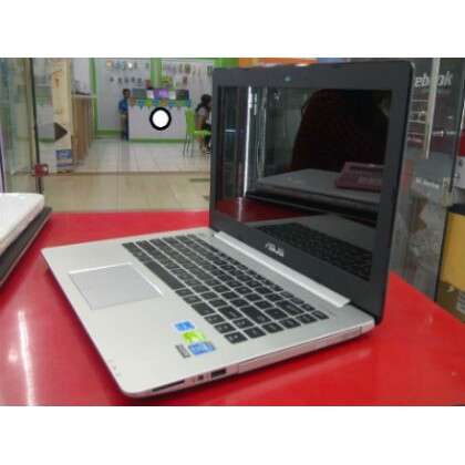 a laptop computer sitting on a red table.