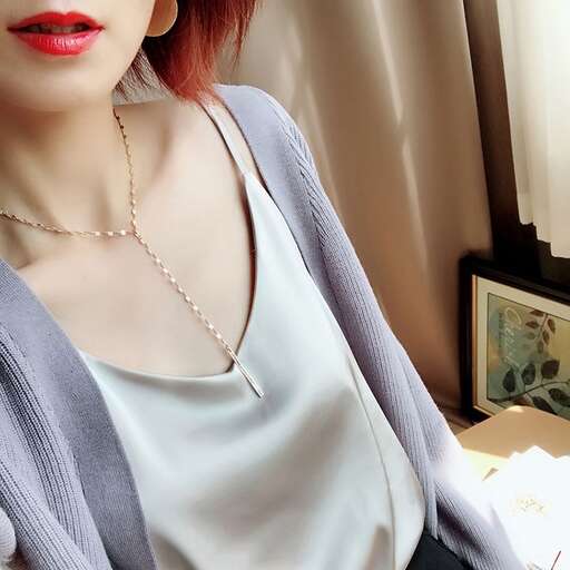 a woman with red lipstick and a pearl necklace