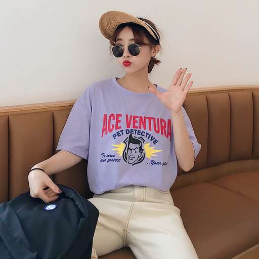 a girl in a hat and sunglasses sitting on a couch